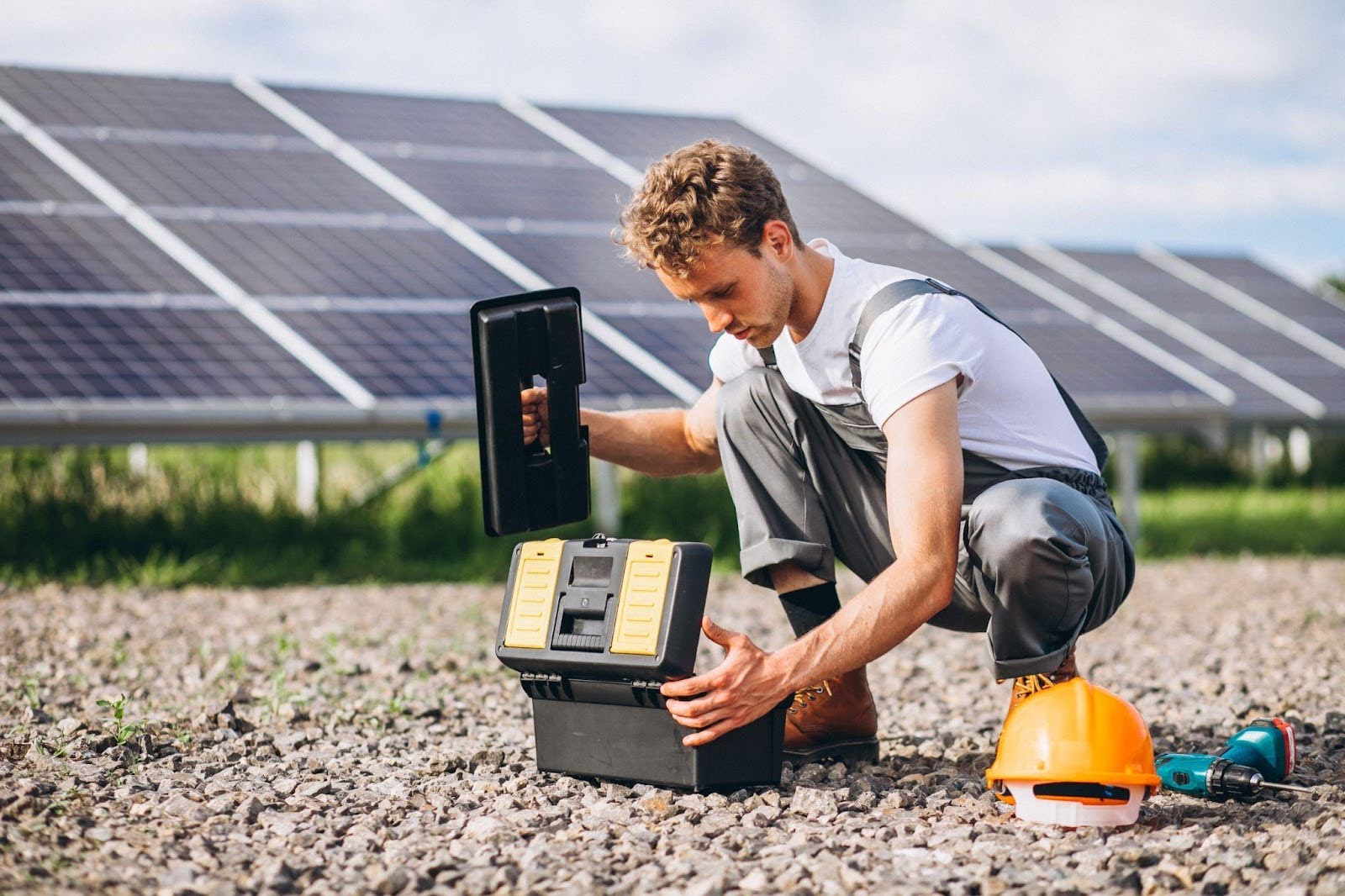 0900 Man working for one of the best solar companies in Bayport, NY, doing the process of solar panel installation on a ground floor<br />