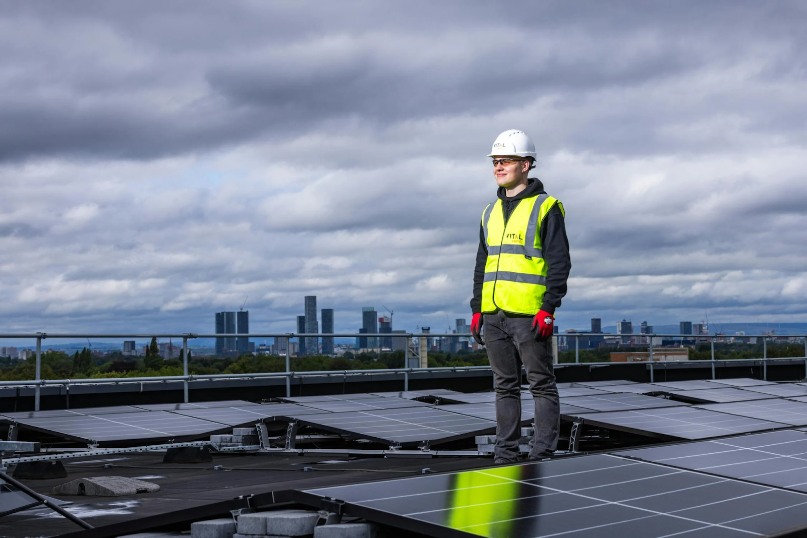 bbbb A man standing among the solar panels installed with professionalism at a commercial area. Call now for a free estimate.
