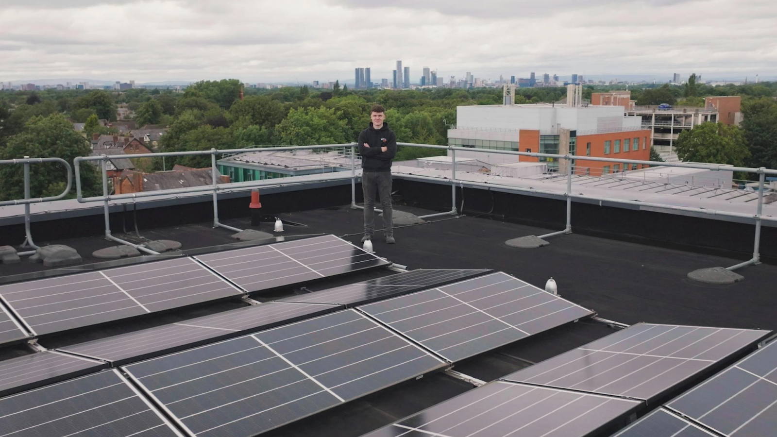 saave A man standing by the solar panels installed on a residential roof. Call now for a free estimate.<br />