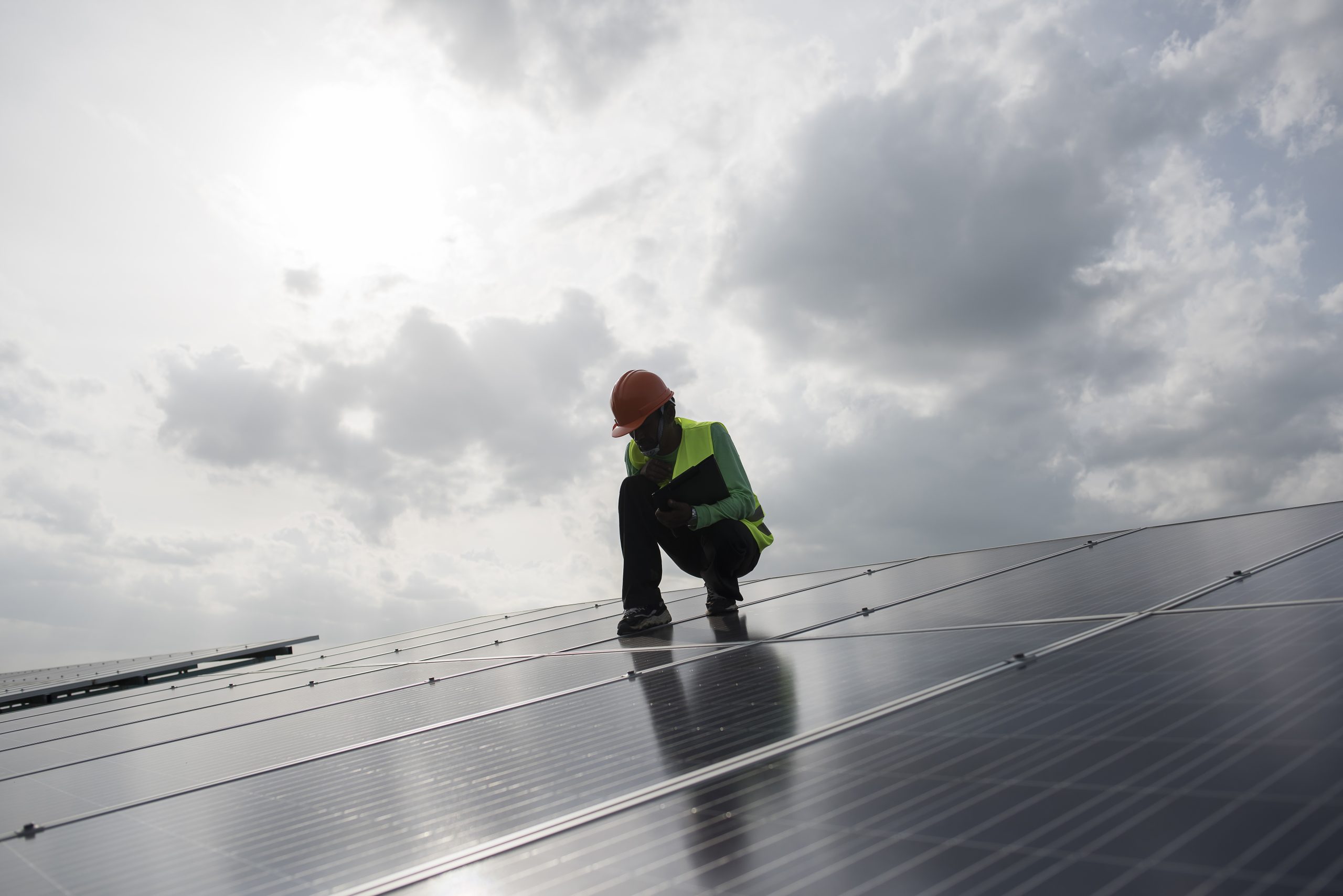 Technician engineer checks the maintenance of the solar cell pan A professional checks the maintenance of the newly installed solar panels on a rooftop. Get in touch today for a free estimate.<br />