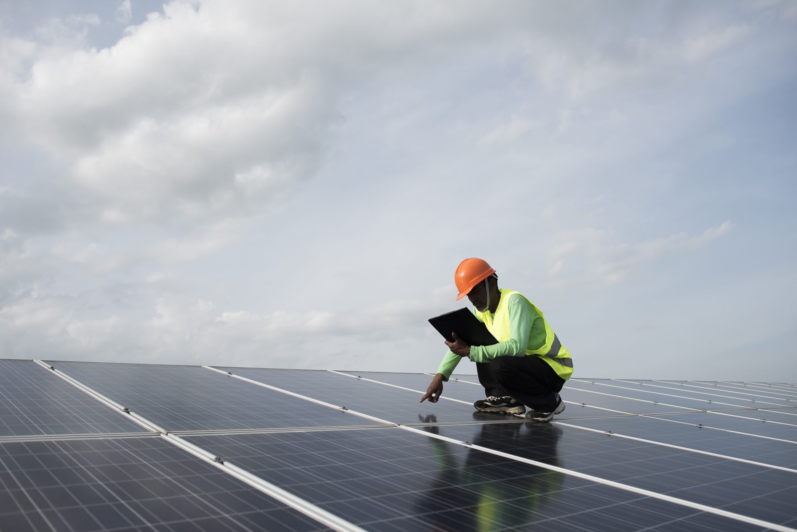 Technician engineer checks the maintenance of the solar cell pan ALT: A professional inspecting the maintenance of solar panels on a rooftop. To get an estimate, get in touch with us today