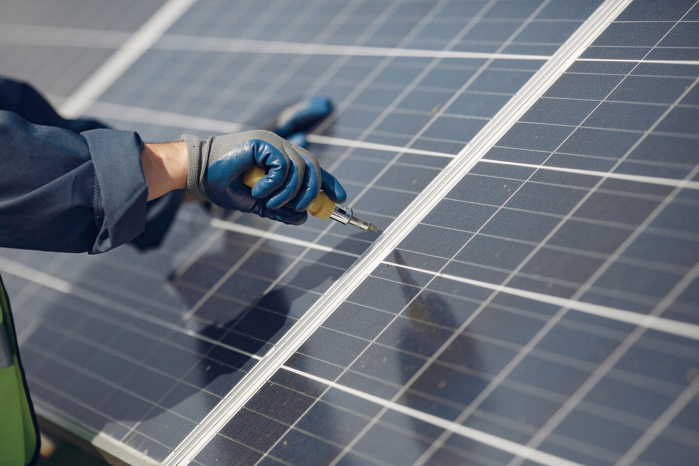 zzz An experienced solar professional installing a solar panel with care. Get in touch today to receive your free estimate.<br />